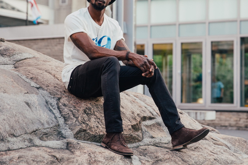 one person, leisure, leisure activity, trip, rocks, front view, youth, casuals, sitting, sits, rock - object, males, traveler, jeans, lifestyle, fashion