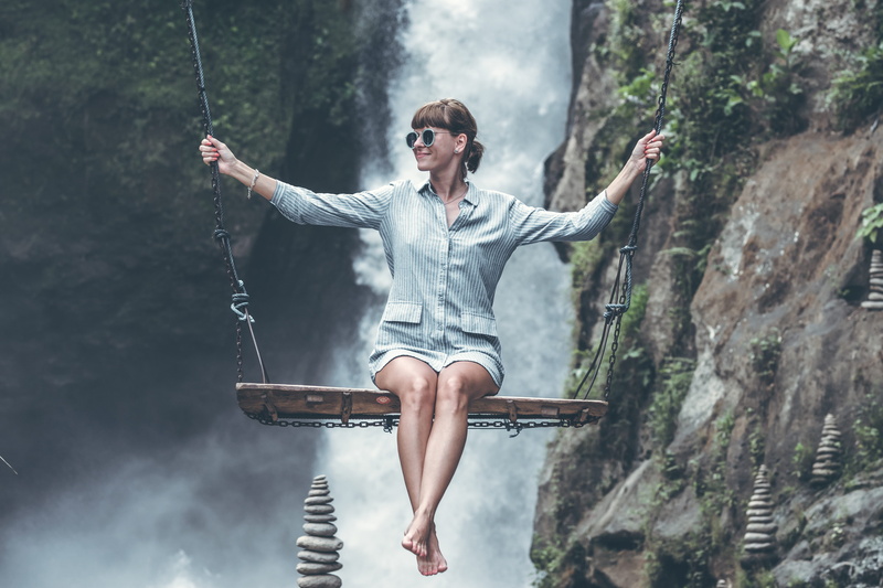 tree, casual clothing, waterfalls, daylight, young women, balance, rope, background, leisure activity, sitting, hanging, daytime, sport, riding, women