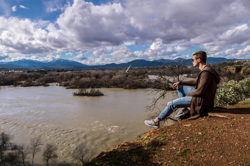 real people, mountains, nature, full length, sky, water, adult, river, relaxation, leisure activity, young adult, lifestyles, sitting, bluffs, beauty in nature