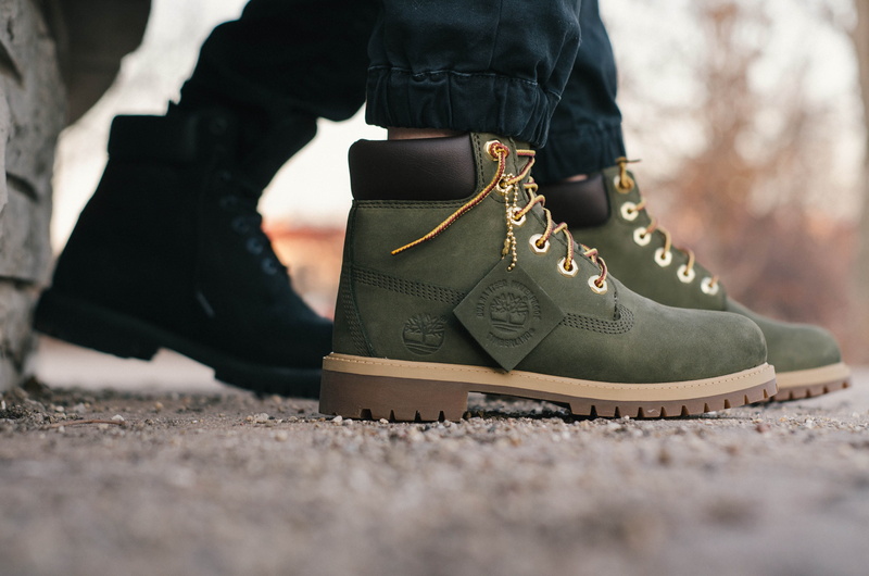 human foot, work, standing, timberland, surface level, clothing, boots, lifestyles, human body part, women, footwear, limb, shoe, outdoors, closeup, person