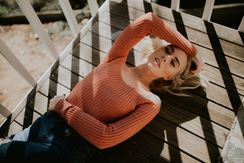 Alysha Nett, hairstyle, chair, blonde, young women, model, beauty, necklace, women outdoors, smiling, bare shoulders, torn jeans, portrait, lying on back