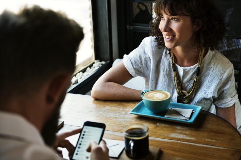 technology, restaurant, meeting, adult, indoors, wireless technology, headshot, speaking, young adult, breakfast, men, sitting, friend, cafe, food and drink