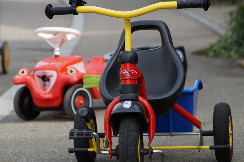 ride, wheel, transportation, handle, land vehicle, play outside, trike, road, city, tricycle, stationary, movement, no people, children, close-up, vehicles
