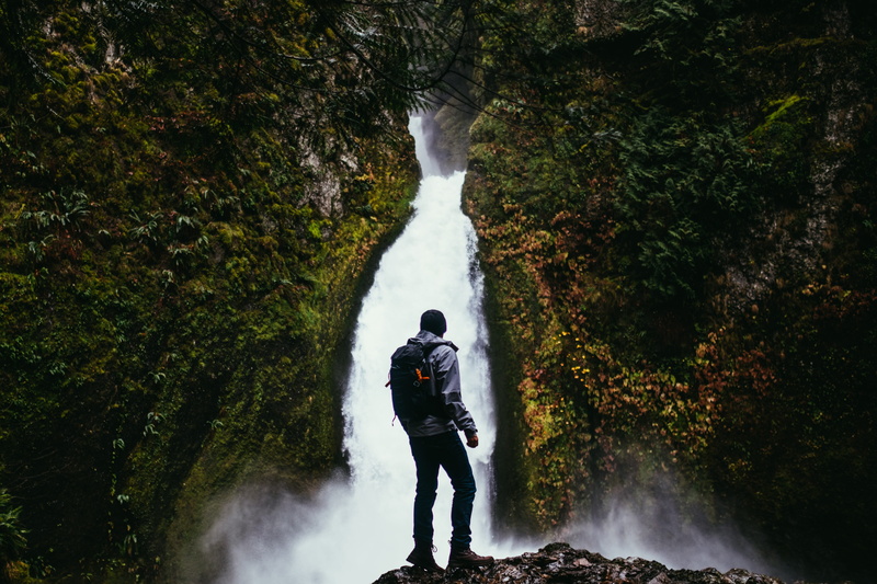 motion, activity, standing, waterfall, nature, man, lifestyles, power in nature, real people, hiker, forest, beauty in nature, hiking, outdoor, cliff, one person