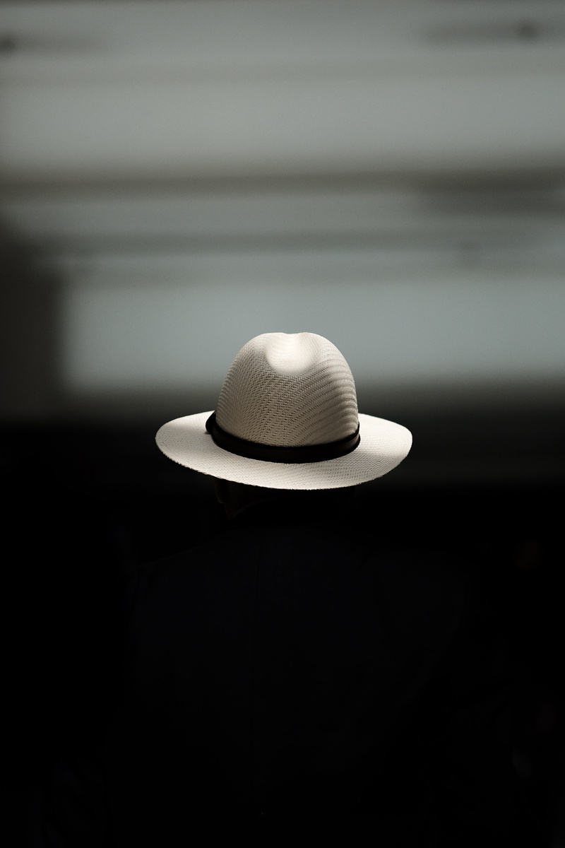 darkroom, arts culture and entertainment, focus on foreground, electric lamp, selective focus, wall - building feature, illuminated, 5K, hat, elegance