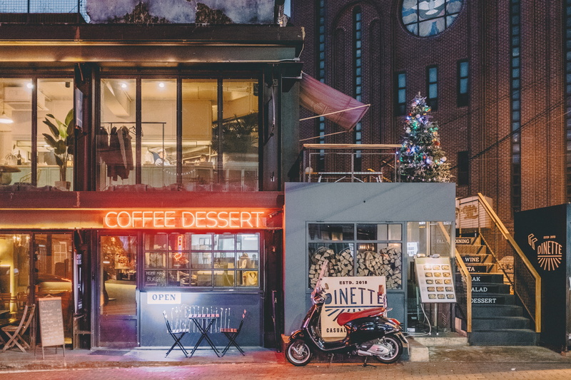 motorcycle, text, store, town, plant, retail, shopping, dessert, meal, glass - material, urban, communication, machine, coffee, kiosk, wheel, outdoors