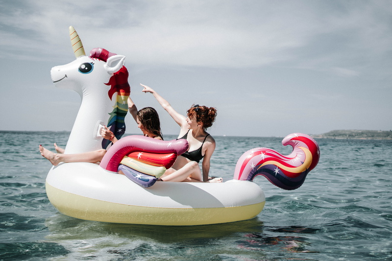 nautical vessel, happiness, floaters, outdoors, women, mode of transportation, girls, vacations, water, recreation, leisure, ocean, inflatable, horizon over water