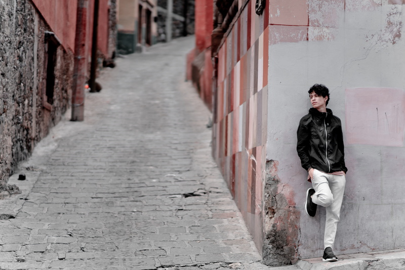 alley, san miguel de allende, day, walkway, young adult, built structure, puma, footpath, wall, cobble, contemplation, street, old, outdoors, brick, building exterior
