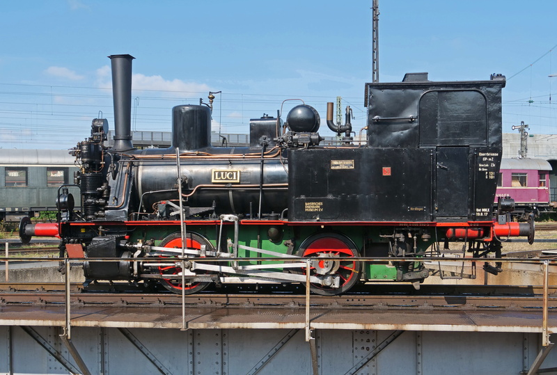 built structure, locomotive, mode of transportation, outdoors, oldtimer, building exterior, small loco, railroad track, hub, exhibit, factory, 5K, two couplers