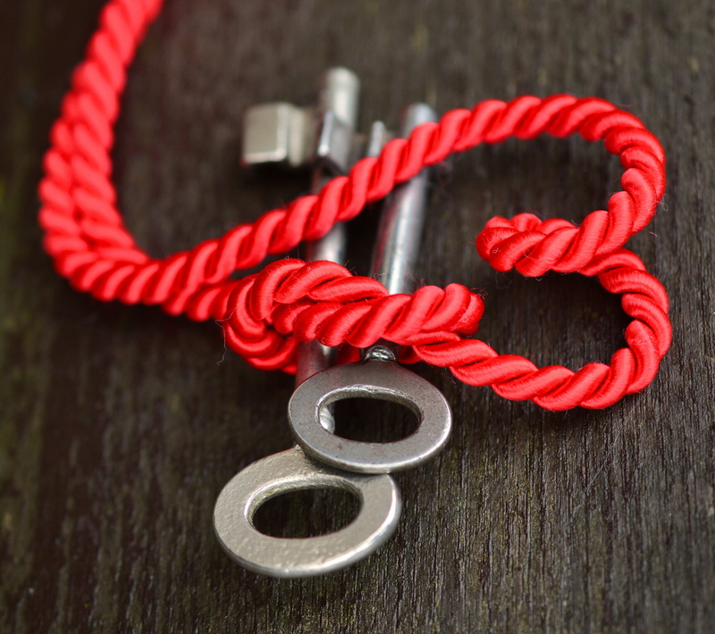 black color, cord, jewelry, high angle view, selective focus, wood - material, rope, selective, connectedness, single object, photography, together, marry