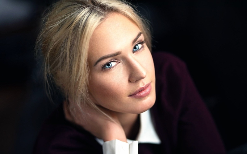 one person, headshot, portrait, blond hair, body part, beauty, human body part, teenager, contemplation, black background, beautiful woman, looking at camera