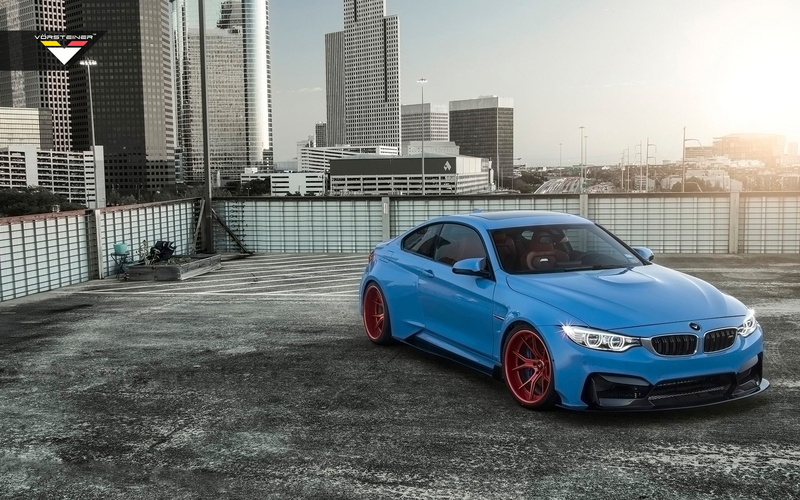 motor vehicle, road, built structure, outdoors, mode of transportation, building exterior, transportation, cityscape, no people, city, skyscraper, blue