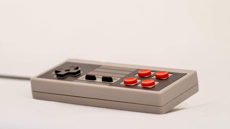 finance, single object, entertainment, hobby, modern, joystick, gaming, leisure games, architecture, computer, red, indoors, cut out, console, focus on foreground