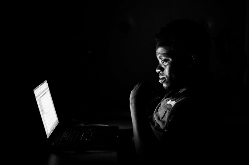 hairstyle, computer, young adult, sitting, headshot, emotion, startup, adult, connection, waist up, dark, business, black and white, night, wireless technology