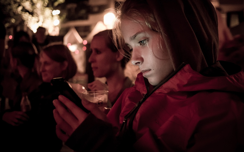 young adult, jacket, mobile phone, adult, smartphone, portable information device, looking, social network, late night, watching, holding, wireless technology