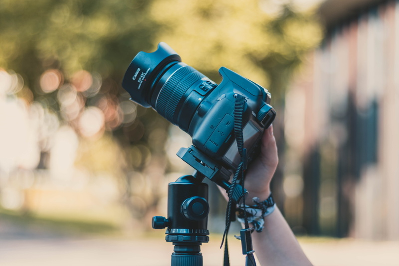 electronics, photographic equipment, real people, lense, accessories, one person, selective focus, tripod, nature, close-up, tech, canon, camera, focus