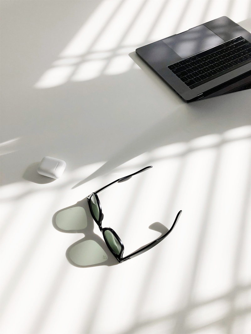 focus on foreground, technology, no people, wayfarer, still life, workspace, table, connection, desk, shadow, photography, lay, macbook, glasses, communication