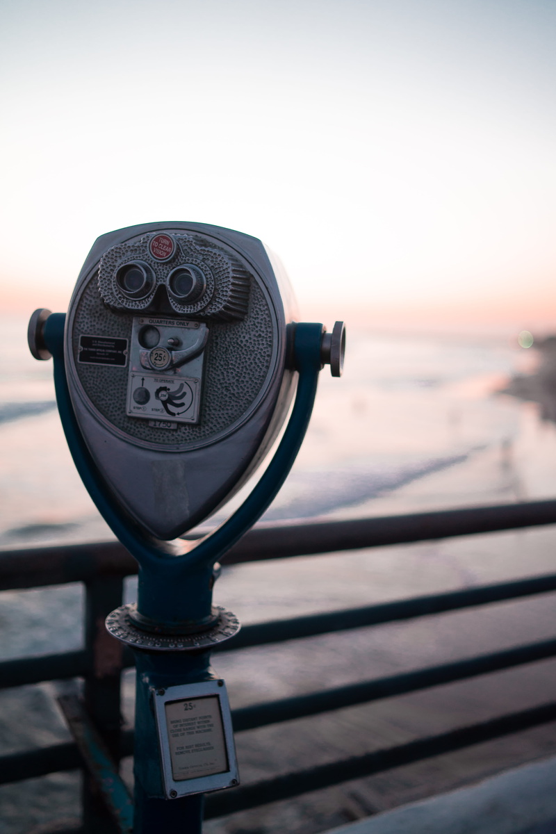 hand-held telescope, 25¢, handheld, railings, sunset, explore, day, railing, ocean, water, beach view, go adventure, security, view, gray, no people, blur
