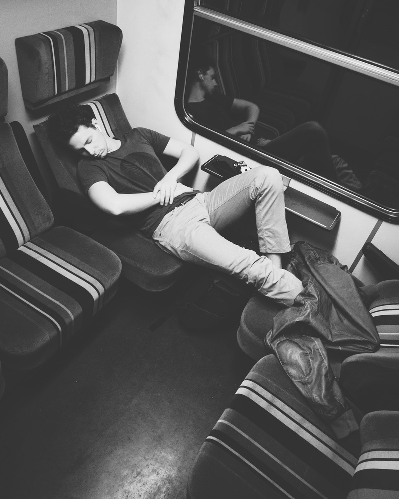 lifestyles, angle, seat, apple, public transportation, black and white, people, restful, train - vehicle, bandw, sleep, passenger, train, earpods, vehicle interior