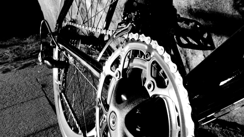 bike, gear, mode of transportation, mechanism, stationary, transportation, land vehicle, high angle view, no people, outdoors, architecture, flywheel, city