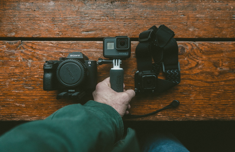 table, hand, camera - photographic equipment, occupation, photography, personal perspective, black, leisure activity, digital single-lens reflex camera
