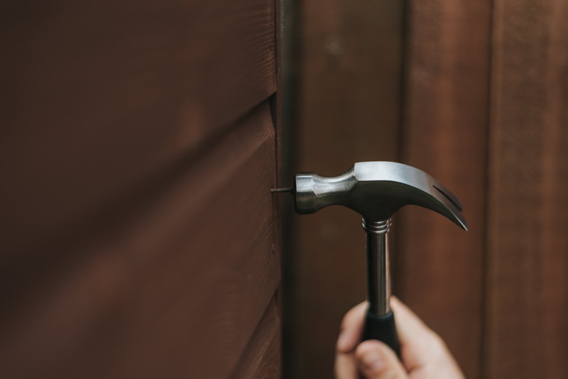 silver colored, wood, curved, fixing, unrecognizable person, wood - material, nails, body part, human body part, claw, fix, holding, iron, day, door, knob