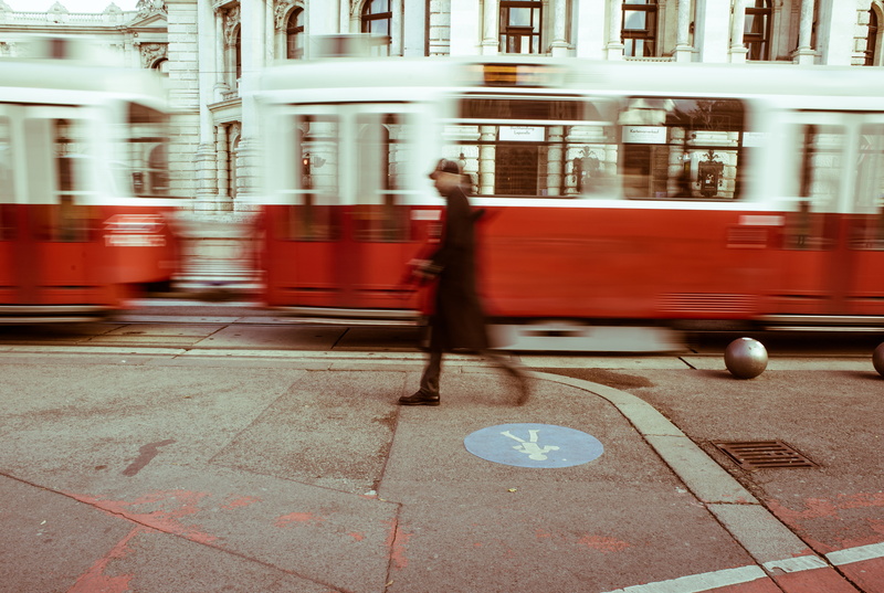 red, photo, building exterior, people, transportation, architecture, near, person, public transportation, built structure, lapse, 5K, train, city life