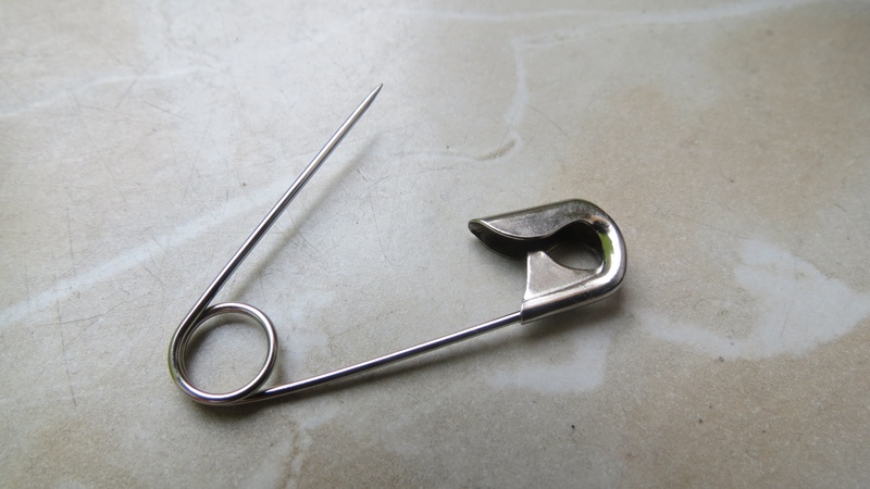 indoors, personal accessory, textile, work tool, silver colored, two objects, man made object, high angle view, harmony, sew, safety pin, no people, paper