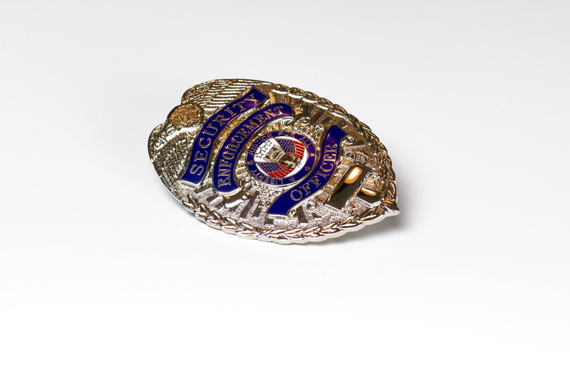 no people, cut out, metal, single object, shield, police, policeman, symbol, gold colored, enforcement, close-up, uniform, finance, badge, indoors, silver