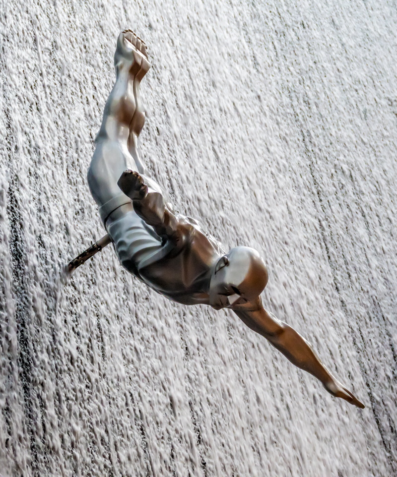 jump, wall - building feature, metal, full length, wall, outdoors, representation, art and craft, nature, statue, built structure, high diver, architecture