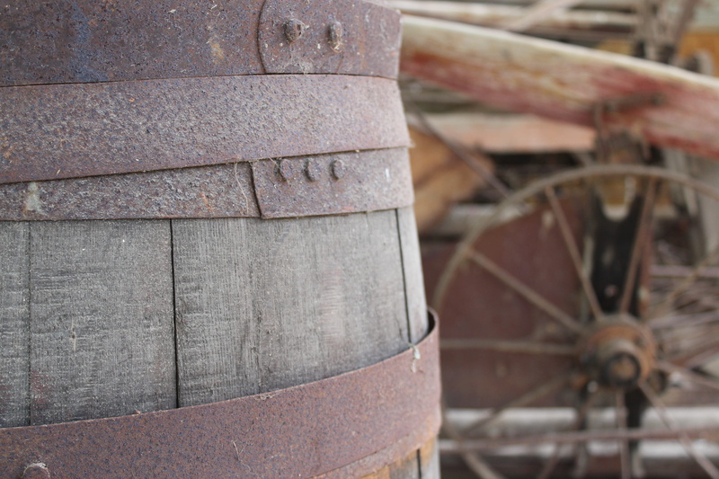shed, mode of transportation, cylinder, obsolete, outdoors, weathered, wood - material, close-up, stack, day, dusty, rusty, transportation, wheel, architecture