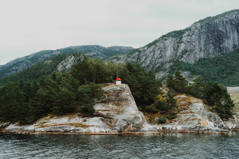 tranquility, lysefjorden, outdoors, water, cliff, lake, red, daytime, non-urban scene, travel, body, nature, tree, wind, mountain, mountain ridge, solid