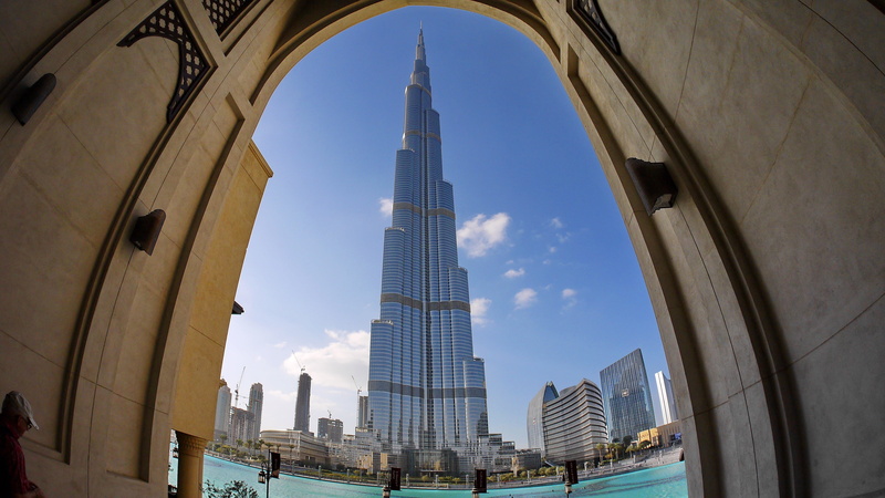 dubai, burj kalifa, low angle view, religion, built structure, arch, holiday, outdoors, rise, city, tourism, day, office building exterior, architecture