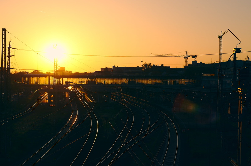 electricity, sunlight, industry, sunshine, eye, silhouette, architecture, light, train, station, infrastructure, sky, orange color, railway, view, outdoors