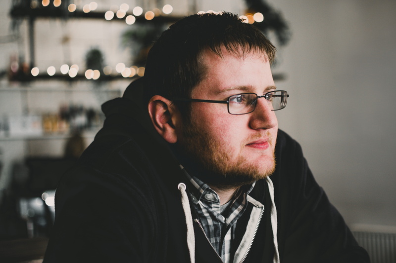 mid adult, 5K, indoors, person, hairstyle, contemplation, portrait, beard, casual clothing, young men, headshot, real people, lights, eyewear, looking away
