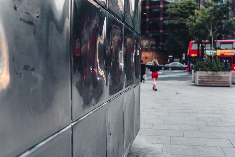 faraday, rail transportation, city, real people, one person, reflections, day, steel facade, reflective, london, mode of transportation, street, walking