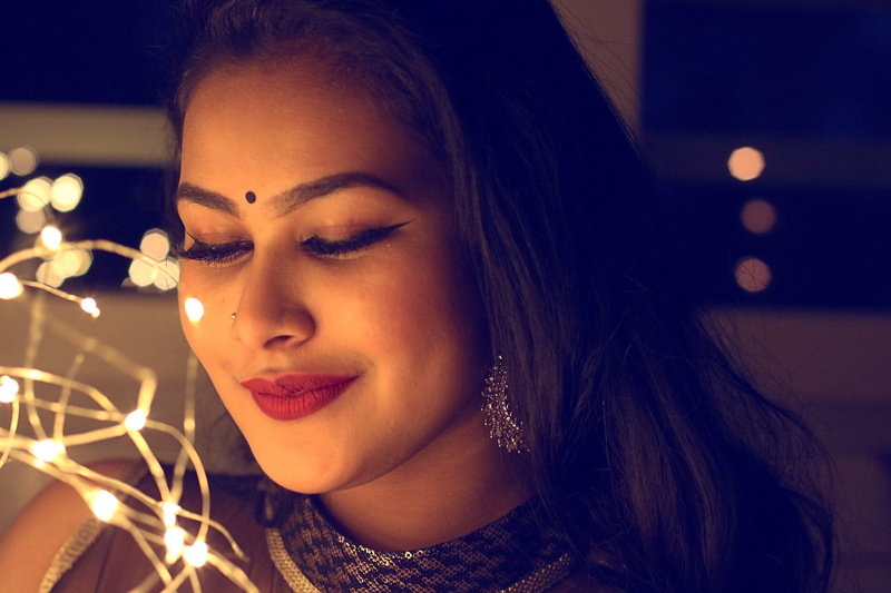 focus on foreground, string lights, beautiful, contemplation, looking down, female, night, beautiful woman, portrait, woman, hair, pretty, close-up, hairstyle