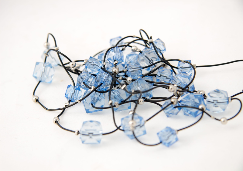 high angle view, colored background, beads, abundance, indoors, silver colored, blue, no people, dark background, tangled, bijouterie, complexity, selective focus