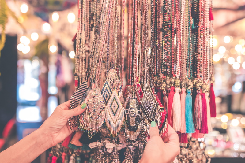 hands, real people, decor, variation, material, for sale, necklaces, tassles, store, business, human body part, human hand, outdoors, hand, jewelry, market stall