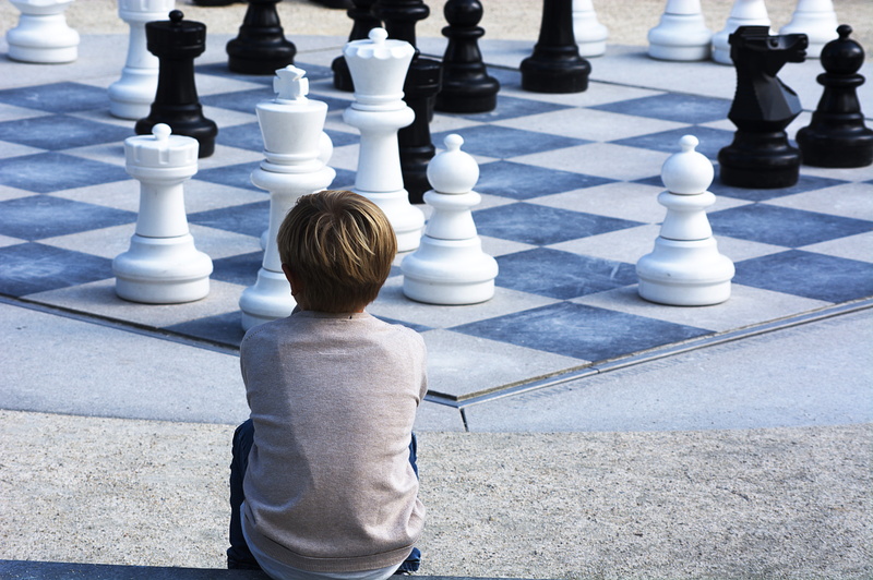leisure activity, childhood, black, game, chess piece, white, queen, landscape, boy, thinking, real people, boys, innocence, day, chessboard, knight - chess piece