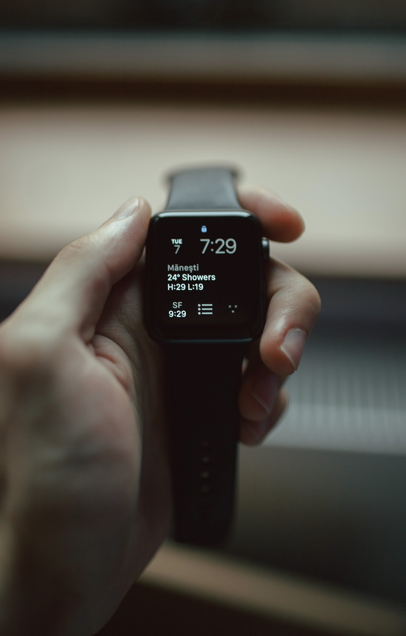 weather app, focus on foreground, holding, clock, watch, selective focus, real people, apple watch, close-up, one person, tech, cell phone, focus, indoors