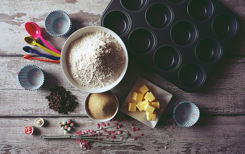 food and drink, variation, bowl, high angle view, kitchen utensil, spice, wood - material, baking, cup cakes, sweet food, table, ingredient, egg, cooking