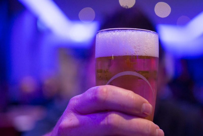celebration, bubbles, filled, colors, pint glass, liquid, focus on foreground, hand, celebratory toast, household equipment, dark, bar - drink establishment