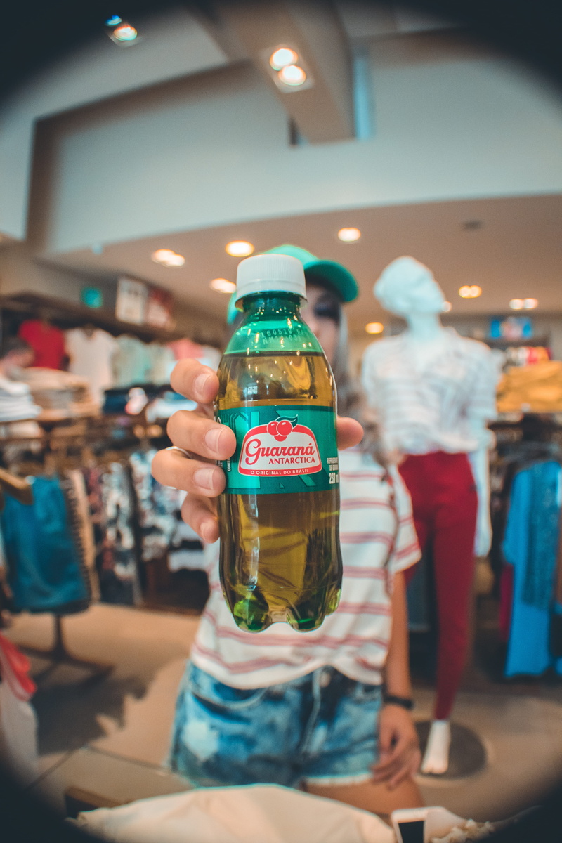 shirt, pub, green, men, indoors, bottle, apparel, 5K, real people, illuminated, focus on foreground, striped, drink, clothing, bar counter, leisure activity