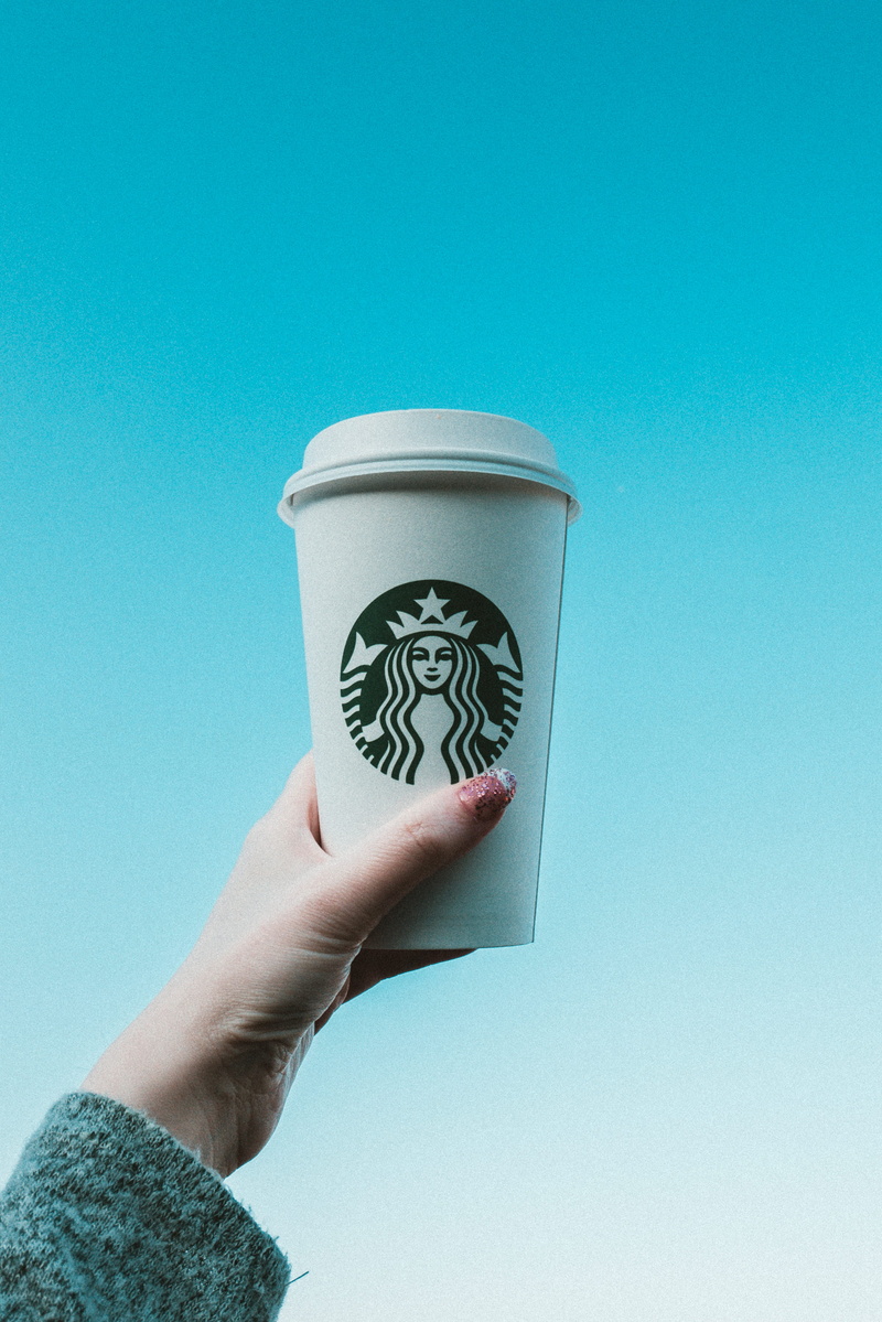 hot beverage, tumblers, cup of coffee, delicious, person, hand, sky, copy space, low angle view, cup, real people, human hand, body part, blue background