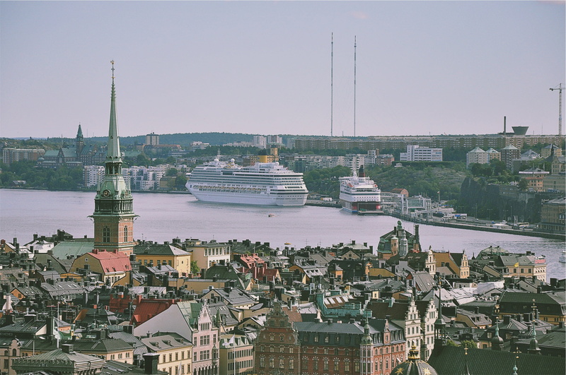 government, cityscape, building, aerial, dock, mosque, city, town, towers, passenger craft, day, near, finial, nautical vessel, sky, yacht, nature, architecture