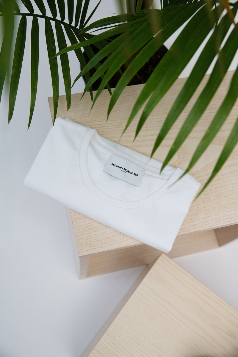 modernessential, clothing, 5K, tabletop, shirt, minimal, newyork, minimalism, white, brand, clean, plant, fashion, top, tee, no People, flat lay, style