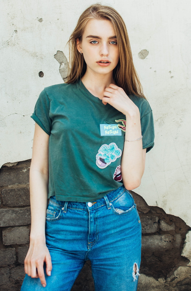 apparel, robe, wall - building feature, shirt, young women, beauty, leisure activity, beautiful woman, beside, jeans, blouse, teenager, neck, hair, looking at camera