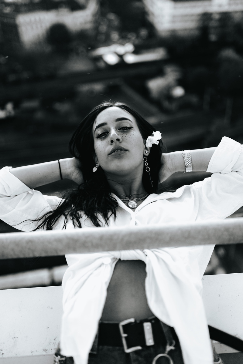 lifestyles, front view, day, outdoors, contemplation, wearing, relax, focus on foreground, flower, leisure activity, 5K, white shirt, one person, portrait