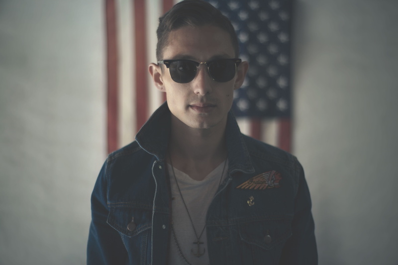 protrait, young adult, usa, neck, banner, jacket, shirt, face, sunglasses, blue, looking at camera, portrait, lifestyles, white, focus on foreground, button